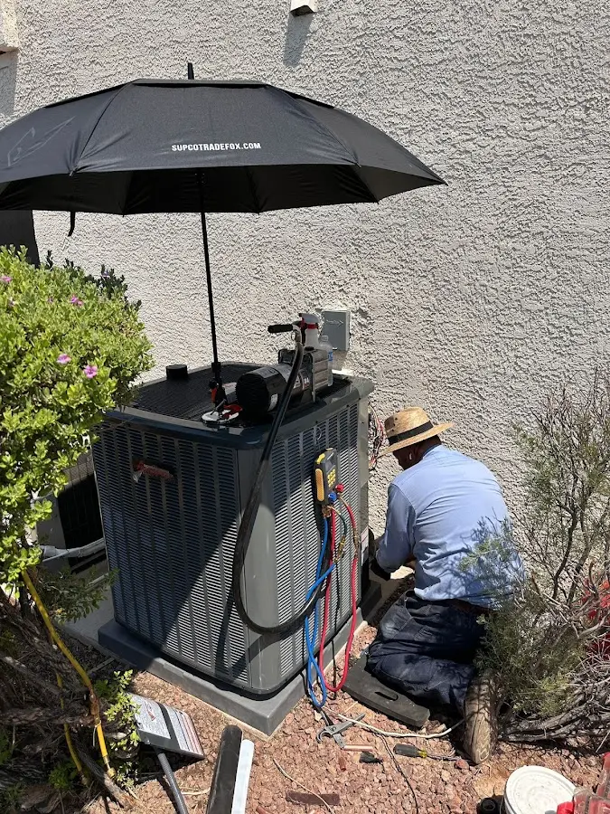 HVAC technician performing outdoor AC maintenance in Fort Wayne